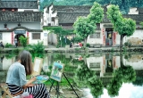 Artist with village reflection